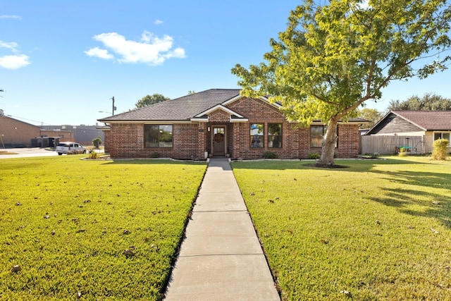 ranch-style home with fence, a front lawn, and brick siding