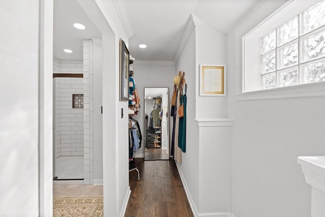 corridor featuring crown molding, baseboards, recessed lighting, and wood finished floors