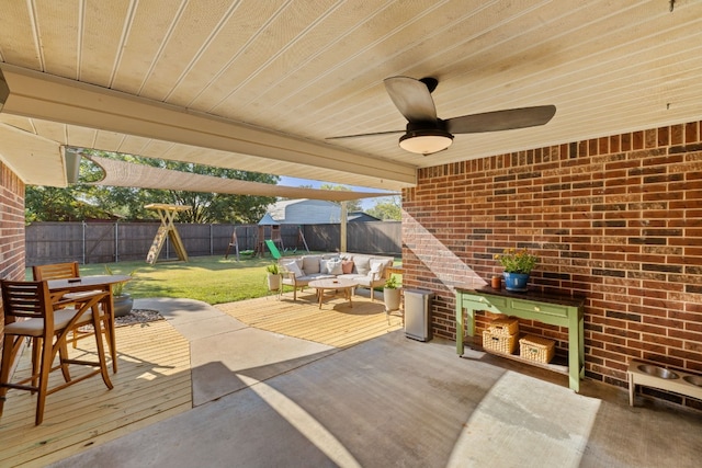 view of patio featuring ceiling fan, outdoor dining area, a fenced backyard, and a playground