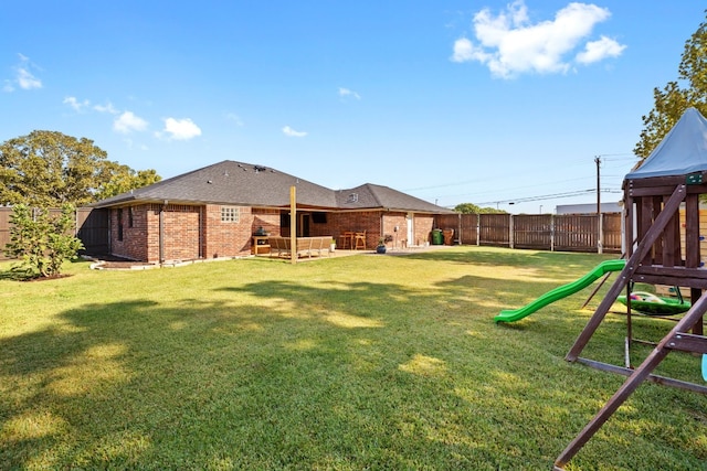 view of yard with a patio, a fenced backyard, and a playground