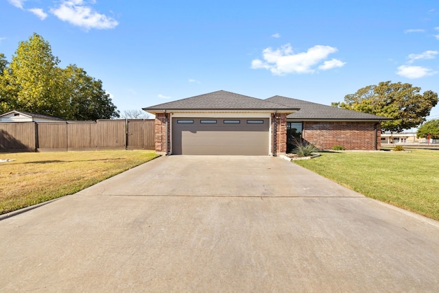 view of front of home featuring a garage and a front lawn