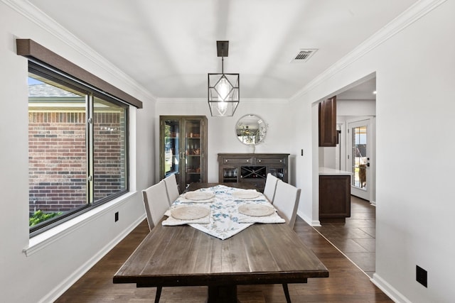 dining room with ornamental molding, dark wood-type flooring, and a wealth of natural light