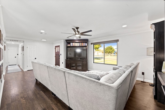 living room featuring dark wood-type flooring, crown molding, and ceiling fan