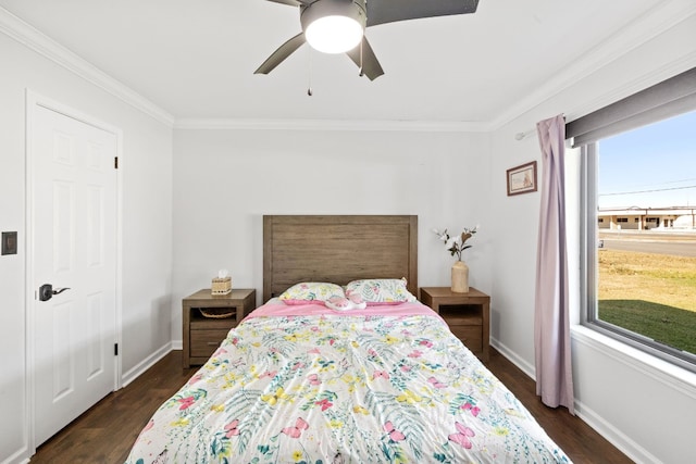 bedroom with crown molding, dark wood-type flooring, and ceiling fan