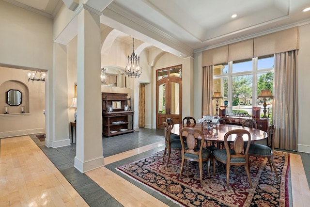 dining area featuring ornamental molding, a notable chandelier, dark hardwood / wood-style floors, and a tray ceiling