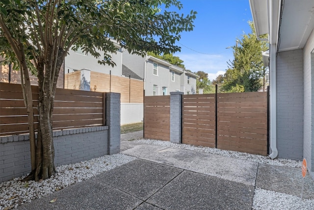 view of gate featuring a patio area