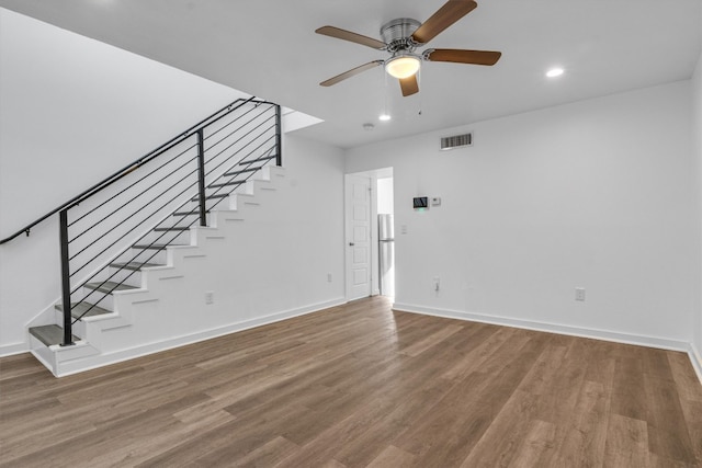 interior space featuring wood-type flooring and ceiling fan