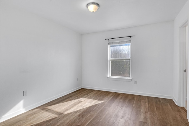 spare room featuring wood-type flooring