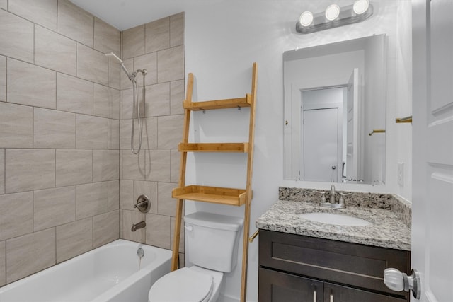 full bathroom with vanity, toilet, and tiled shower / bath