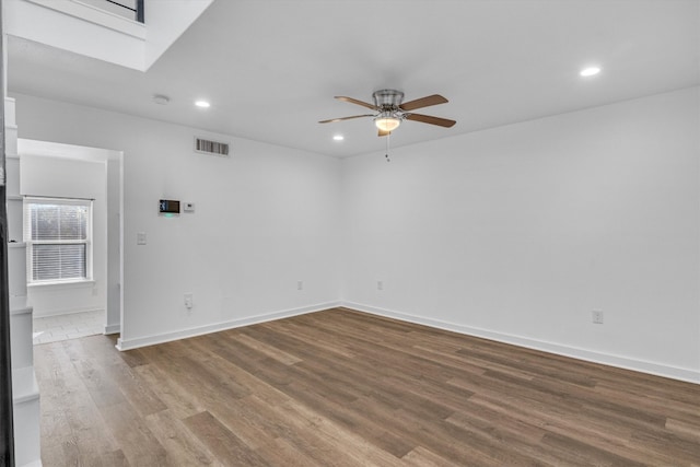 empty room featuring wood-type flooring and ceiling fan