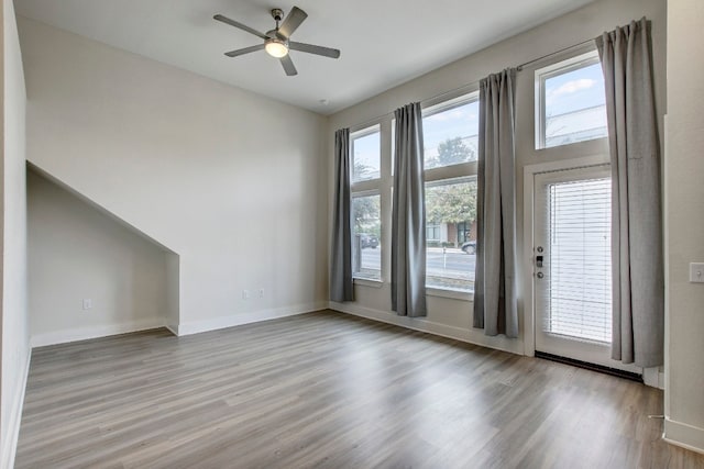 spare room with ceiling fan and light hardwood / wood-style flooring