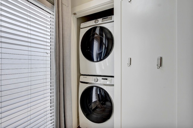 clothes washing area with stacked washer / drying machine