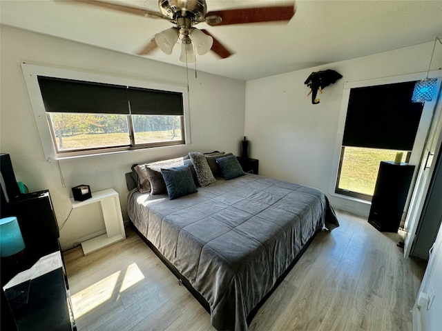 bedroom featuring light wood-type flooring and ceiling fan