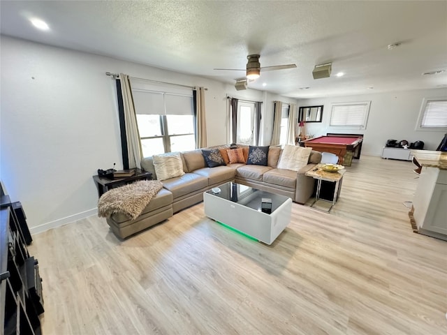 living room with pool table, a textured ceiling, light wood-type flooring, and ceiling fan