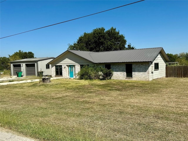 single story home featuring a front lawn and a garage