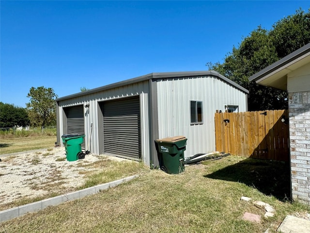 view of outdoor structure with a lawn and a garage