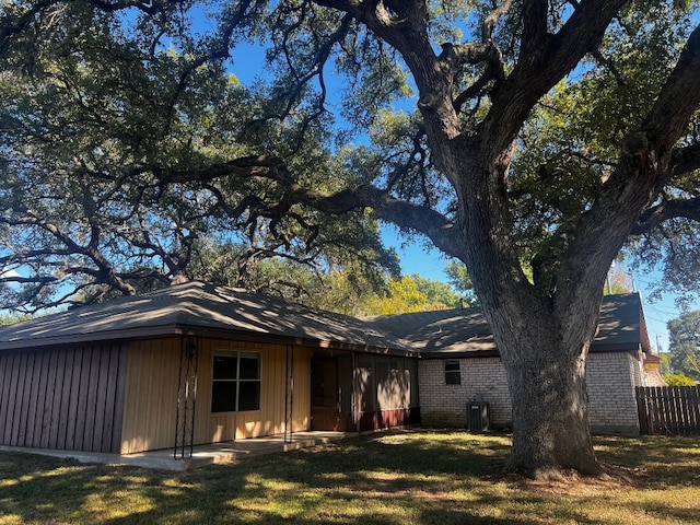 rear view of property featuring a lawn