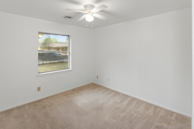 carpeted spare room with ceiling fan