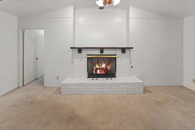 unfurnished living room featuring a fireplace, vaulted ceiling, and light colored carpet