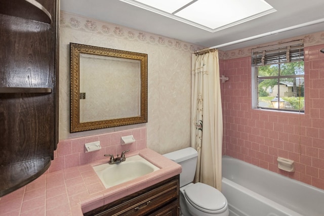 full bathroom with vanity, toilet, tasteful backsplash, and shower / tub combo