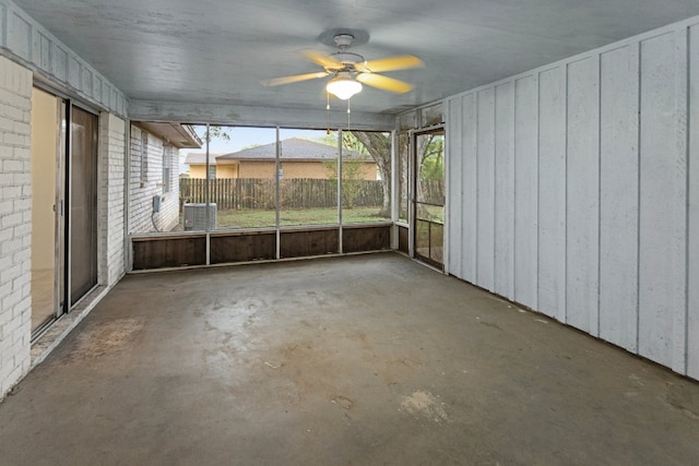 unfurnished sunroom featuring ceiling fan