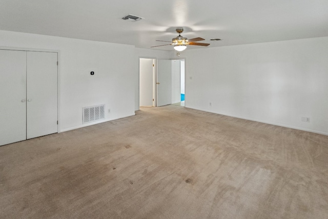 spare room with light carpet and ceiling fan