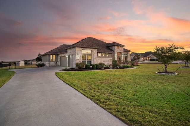 view of front of home with a lawn and a garage