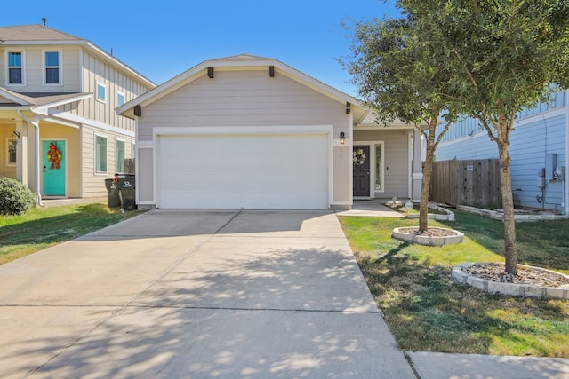 view of front of property featuring a front yard and a garage