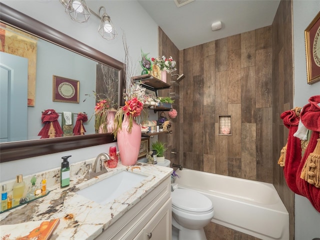 full bathroom featuring toilet, vanity, and tub / shower combination