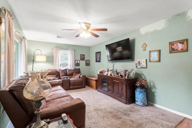 106 Hudgins St, Smithville, TX 78957 - living room with ceiling fan, a textured wall, a textured ceiling, and carpet floors