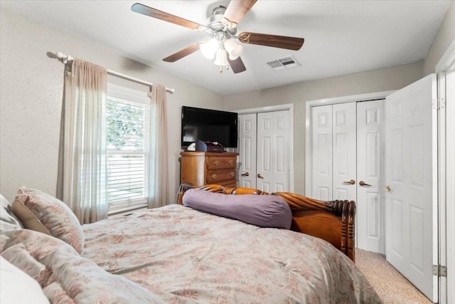 106 Hudgins St, Smithville, TX 78957 - bedroom featuring two closets, carpet, and ceiling fan