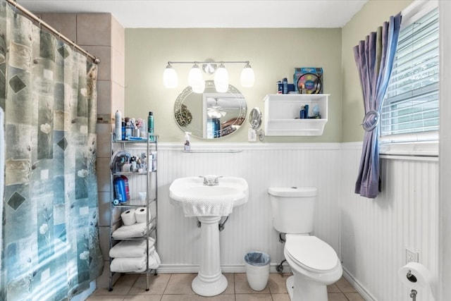 bathroom with tile patterned flooring, a shower with curtain, toilet, and sink