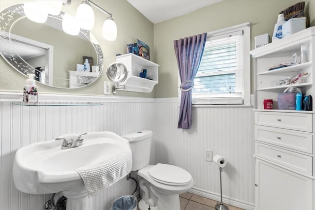 106 Hudgins St, Smithville, TX 78957 - half bath with tile patterned floors and a wainscoted wall