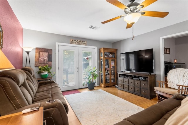 living room with french doors and light hardwood / wood-style flooring