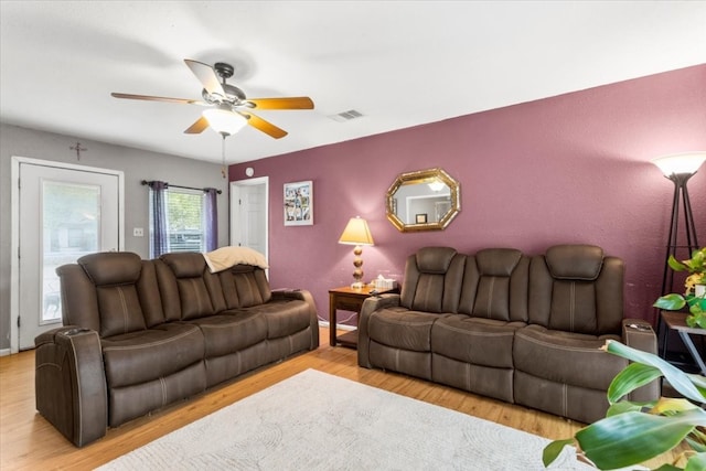 living room with ceiling fan and light wood-type flooring