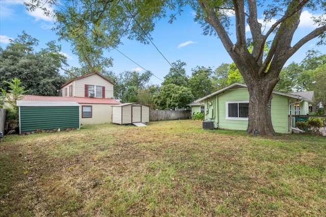 view of yard featuring central AC unit and a storage unit