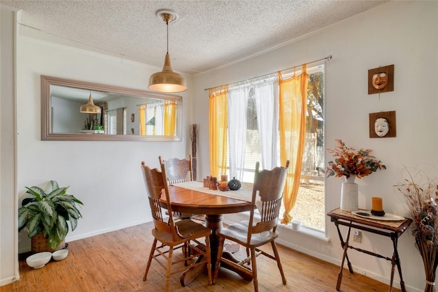 dining room featuring a textured ceiling and hardwood / wood-style floors