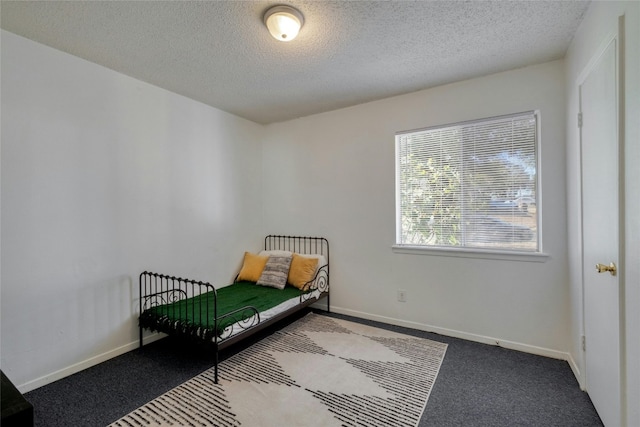 carpeted bedroom featuring a textured ceiling