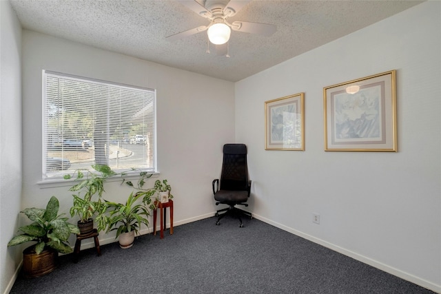 sitting room featuring a textured ceiling, dark carpet, and ceiling fan