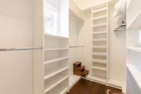 spacious closet with dark wood-type flooring