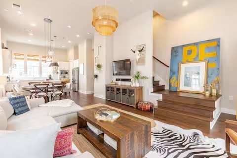 living room with recessed lighting, wood finished floors, baseboards, and stairs