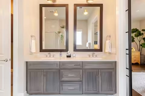 full bathroom featuring double vanity and a sink