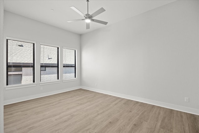 empty room with ceiling fan and light hardwood / wood-style floors