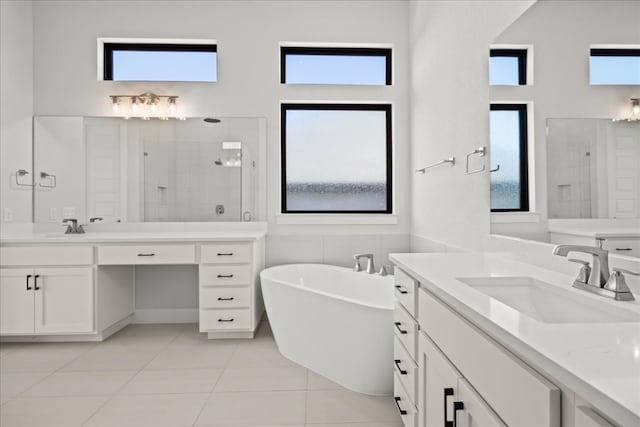 bathroom with tile patterned flooring, shower with separate bathtub, and a wealth of natural light