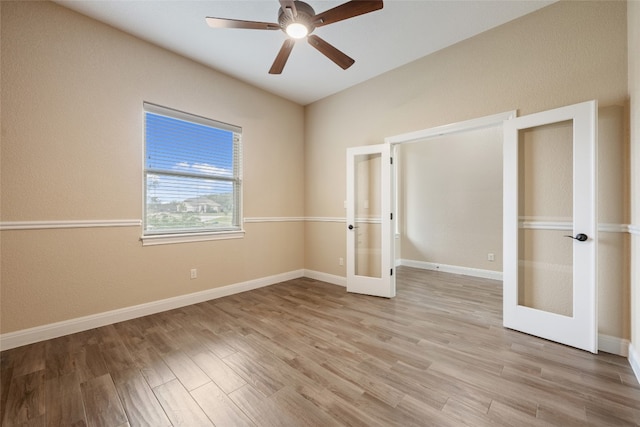 unfurnished bedroom featuring ceiling fan, french doors, and light hardwood / wood-style flooring