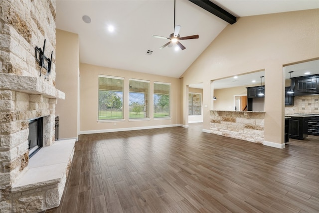 unfurnished living room featuring a fireplace, dark wood-type flooring, high vaulted ceiling, and beamed ceiling