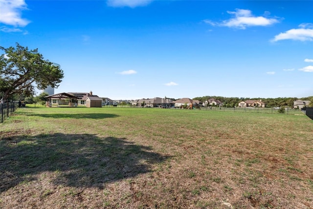 view of yard featuring an outdoor structure and fence