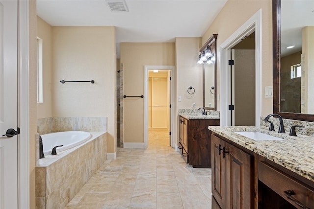 bathroom with vanity and plus walk in shower