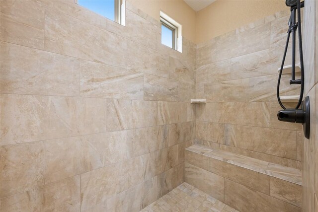 bathroom with a tile shower