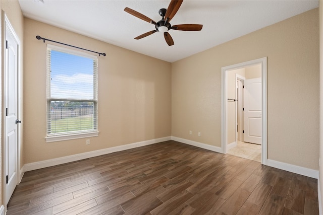 unfurnished bedroom featuring ceiling fan and dark hardwood / wood-style floors